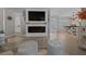 Stylish open-concept living space with a modern fireplace, comfortable seating, and an inviting atmosphere at 9463 Sw 93Rd Loop, Ocala, FL 34481