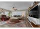 Comfortable living room featuring a TV, area rug and cozy seating area at 9463 Sw 93Rd Loop, Ocala, FL 34481