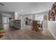 Bright, open living space featuring a modern kitchen, breakfast bar, and dining area with stylish furnishings at 9463 Sw 93Rd Loop, Ocala, FL 34481