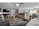 Open-concept living area with a fireplace, modern furnishings, and bright, airy atmosphere at 9463 Sw 93Rd Loop, Ocala, FL 34481