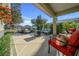 Covered outdoor patio with comfortable seating and a stylish fire pit table perfect for entertaining guests at 9463 Sw 93Rd Loop, Ocala, FL 34481