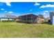 A spacious backyard featuring a screened lanai, perfect for outdoor entertainment at 9841 Sw 95Th Loop, Ocala, FL 34481