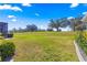 Large, grassy backyard with views of the golf course and a screened lanai at 9841 Sw 95Th Loop, Ocala, FL 34481
