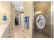 Elegant bathroom with a glass shower featuring a decorative design and neutral tile, plus a walk-in closet at 9841 Sw 95Th Loop, Ocala, FL 34481