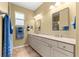 Stylish bathroom showcasing double sinks, a large mirror, and a neutral color palette for a serene atmosphere at 9841 Sw 95Th Loop, Ocala, FL 34481