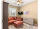Comfortable bedroom featuring a cozy sofa, ottoman, ceiling fan, and natural light at 9841 Sw 95Th Loop, Ocala, FL 34481