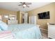 Serene bedroom with ample natural light, ceiling fan, and adjacent desk space at 9841 Sw 95Th Loop, Ocala, FL 34481