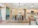 Inviting dining room with decorative rug and light fixture with access to kitchen and outdoor space at 9841 Sw 95Th Loop, Ocala, FL 34481
