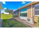 Exterior view of the home with a screened lanai and well-kept landscaping at 9841 Sw 95Th Loop, Ocala, FL 34481