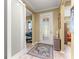 Inviting foyer showcasing sliding doors for office access, and a glass front door, and light hardwood floors at 9841 Sw 95Th Loop, Ocala, FL 34481