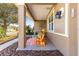 Charming covered front porch with seating area, complemented by stylish decor and a welcoming ambiance at 9841 Sw 95Th Loop, Ocala, FL 34481