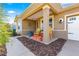 Cozy front porch with seating, decorative accents, and manicured landscaping enhancing the curb appeal at 9841 Sw 95Th Loop, Ocala, FL 34481