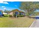 Charming home with a well-manicured lawn, mature landscaping, and an attached garage at 9841 Sw 95Th Loop, Ocala, FL 34481