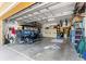 Spacious garage with a golf cart, storage solutions, and ample room for vehicles and equipment at 9841 Sw 95Th Loop, Ocala, FL 34481