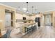 Inviting kitchen island featuring granite countertops, breakfast bar, pendant lighting, and modern appliances at 9841 Sw 95Th Loop, Ocala, FL 34481