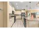 Modern kitchen showcasing granite countertops, black appliances, stylish cabinetry, and open layout at 9841 Sw 95Th Loop, Ocala, FL 34481