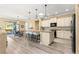 Kitchen and dining area with granite counters, stainless appliances, stylish lighting, and breakfast bar at 9841 Sw 95Th Loop, Ocala, FL 34481