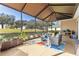 Enjoy the outdoors from this screened lanai with seating and scenic golf course views at 9841 Sw 95Th Loop, Ocala, FL 34481