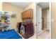 Functional laundry room with modern appliances, storage cabinets, and a folding area for convenience at 9841 Sw 95Th Loop, Ocala, FL 34481