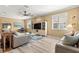 Spacious living room with hardwood floors, comfortable seating, and ample natural light from the windows at 9841 Sw 95Th Loop, Ocala, FL 34481