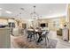 Open-concept space with modern light fixtures, cozy living room, dining area, and kitchen at 9841 Sw 95Th Loop, Ocala, FL 34481