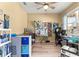 Bright office space featuring a ceiling fan, natural light, and ample desk space for productivity at 9841 Sw 95Th Loop, Ocala, FL 34481
