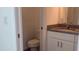 Modern bathroom featuring granite countertops, white cabinetry, and contemporary fixtures at Tbd Malauka Rd, Ocklawaha, FL 32179