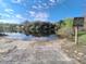 Community boat ramp with beach access to water, with posted 'idle speed' sign to promote water safety at Tbd Malauka Rd, Ocklawaha, FL 32179