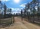Property entrance with gate, natural landscape and blue skies at Tbd Malauka Rd, Ocklawaha, FL 32179