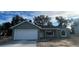 Charming single Gathering home with an attached garage, and a freshly landscaped yard with blue skies at Tbd Malauka Rd, Ocklawaha, FL 32179