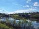 Scenic lake view showcasing the dam and surrounding community at Tbd Malauka Rd, Ocklawaha, FL 32179