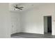 Bright, open-concept living room featuring wood floors, a ceiling fan and new paint at Tbd Malauka Rd, Ocklawaha, FL 32179