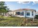 Backyard view of home featuring an enclosed sunroom and patio at 10071 Sw 90Th Loop, Ocala, FL 34481