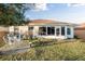 Outdoor patio featuring table and chairs, adjacent to the enclosed lanai at 10071 Sw 90Th Loop, Ocala, FL 34481