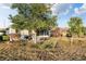 Backyard view featuring a large tree and outdoor seating at 10071 Sw 90Th Loop, Ocala, FL 34481