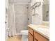 Bathroom featuring tiled shower, granite countertop, and modern fixtures at 10071 Sw 90Th Loop, Ocala, FL 34481