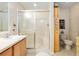 Bright bathroom featuring a walk-in shower with glass doors and a single sink vanity at 10071 Sw 90Th Loop, Ocala, FL 34481