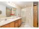 Bathroom featuring a double sink vanity, a shower with sliding glass doors, and neutral decor at 10071 Sw 90Th Loop, Ocala, FL 34481