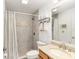 Bathroom with tiled shower, granite countertop, and modern fixtures at 10071 Sw 90Th Loop, Ocala, FL 34481