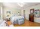 Comfortable bedroom features wood floors, neutral walls, and a cozy, well-decorated bed at 10071 Sw 90Th Loop, Ocala, FL 34481