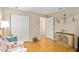 Charming bedroom featuring wood floors and a double door closet at 10071 Sw 90Th Loop, Ocala, FL 34481