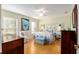 Charming bedroom showcasing hardwood floors, and a comfortable bed with decorative pillows at 10071 Sw 90Th Loop, Ocala, FL 34481