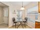 Cozy breakfast nook features a glass table set next to a window with natural light at 10071 Sw 90Th Loop, Ocala, FL 34481