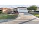 Exterior features include a driveway, a two-car garage, and well-kept landscaping at 10071 Sw 90Th Loop, Ocala, FL 34481