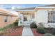 Inviting front porch with cozy seating area and a view of the charming neighborhood at 10071 Sw 90Th Loop, Ocala, FL 34481