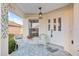 A view of the inviting front porch with seating and exterior door at 10071 Sw 90Th Loop, Ocala, FL 34481