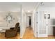 Hallway showcasing wood flooring and access to multiple rooms at 10071 Sw 90Th Loop, Ocala, FL 34481