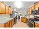Functional kitchen featuring granite countertops, stainless steel appliances, and wooden cabinetry at 10071 Sw 90Th Loop, Ocala, FL 34481