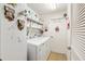 Functional laundry room equipped with washer, dryer, and shelving at 10071 Sw 90Th Loop, Ocala, FL 34481