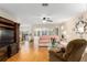 Living room with hardwood floors, ceiling fan, and sofas at 10071 Sw 90Th Loop, Ocala, FL 34481